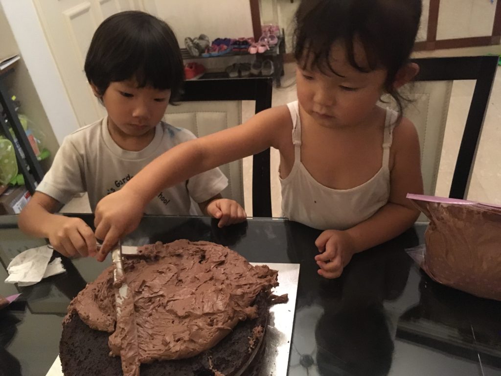 Hard at work, spreading the chocolate frosting